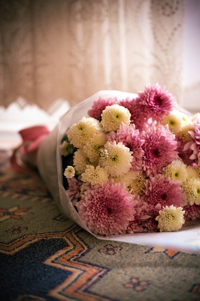 A delicate bouquet of pink and white chrysanthemums, perfect for celebrations or decorating a room in spring.